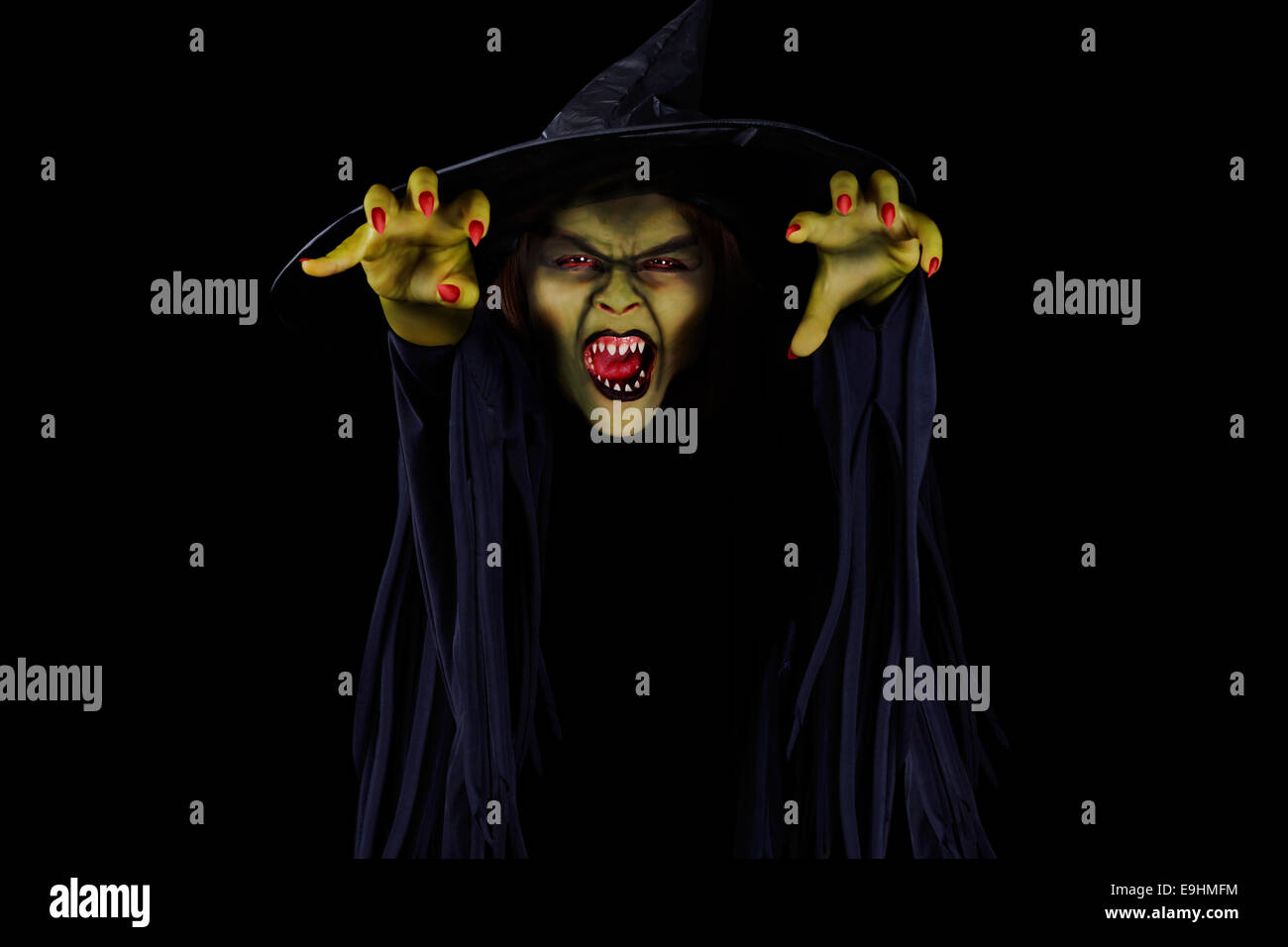 Scary wicked witch trying to catch viewer, Halloween concept Stock Photo
