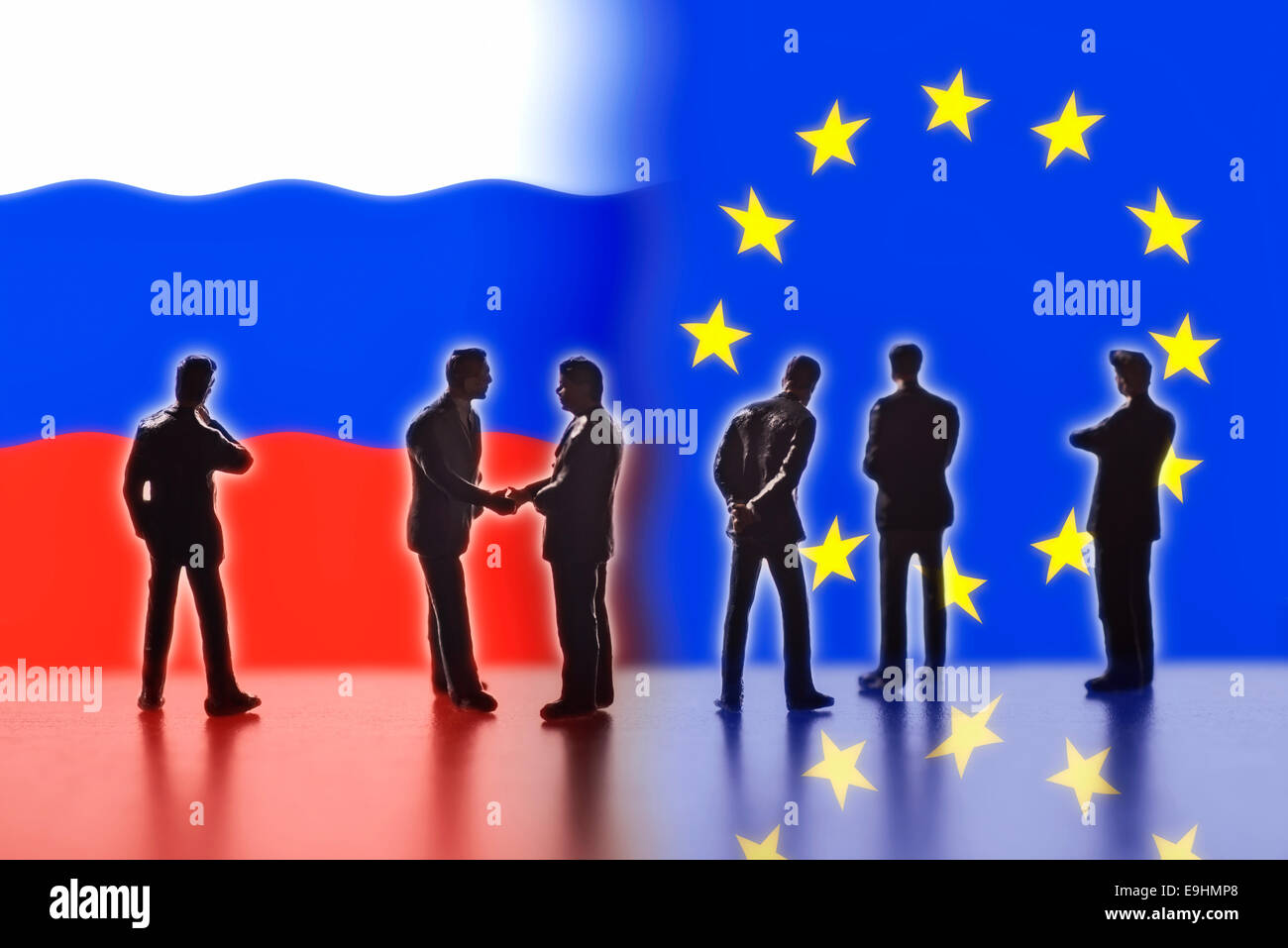 Model figures symbolizing the politicians are faced with the flags of Russia and the EU. Two of them shake hands. Digital Composite (DC) Stock Photo