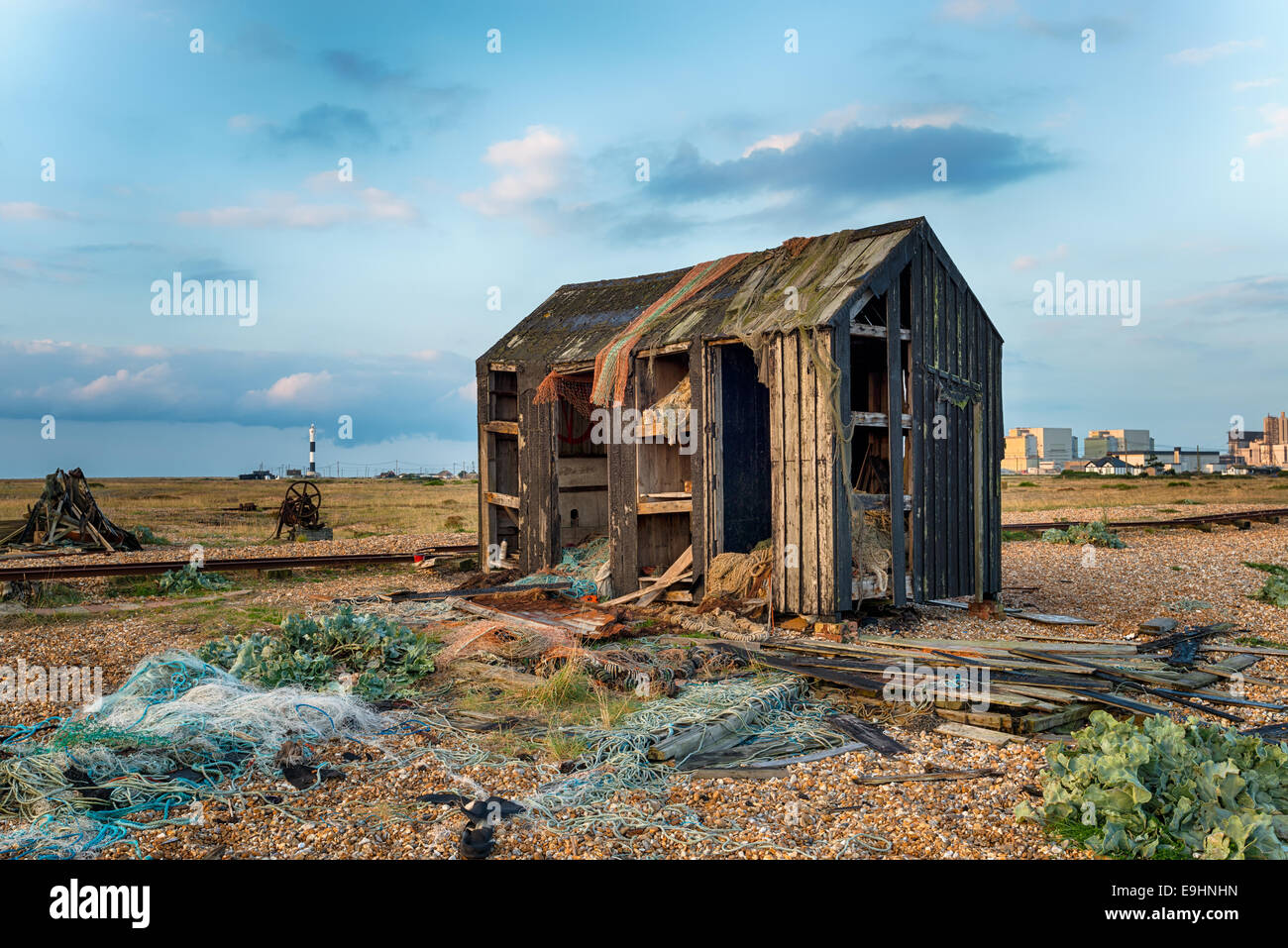 An abandoned fisherman's hut fallen into ruin and disrepair on Dungeness beach in Kent Stock Photo