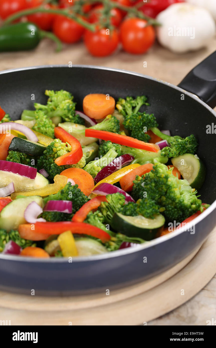 Healthy eating preparing food vegetables in cooking pan Stock Photo