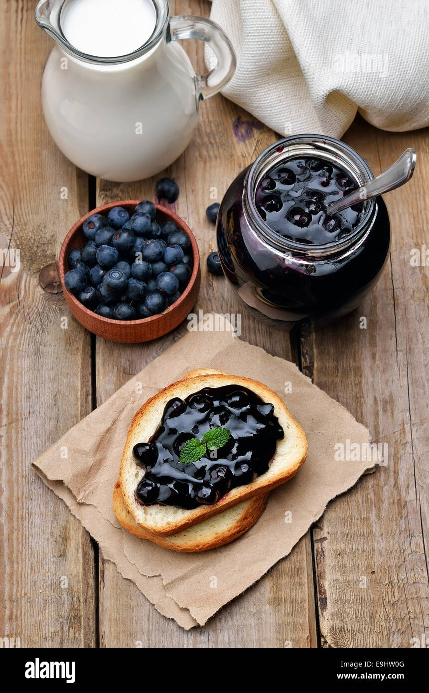 Toasted bread with blueberry jam on wooden table Stock Photo Alamy
