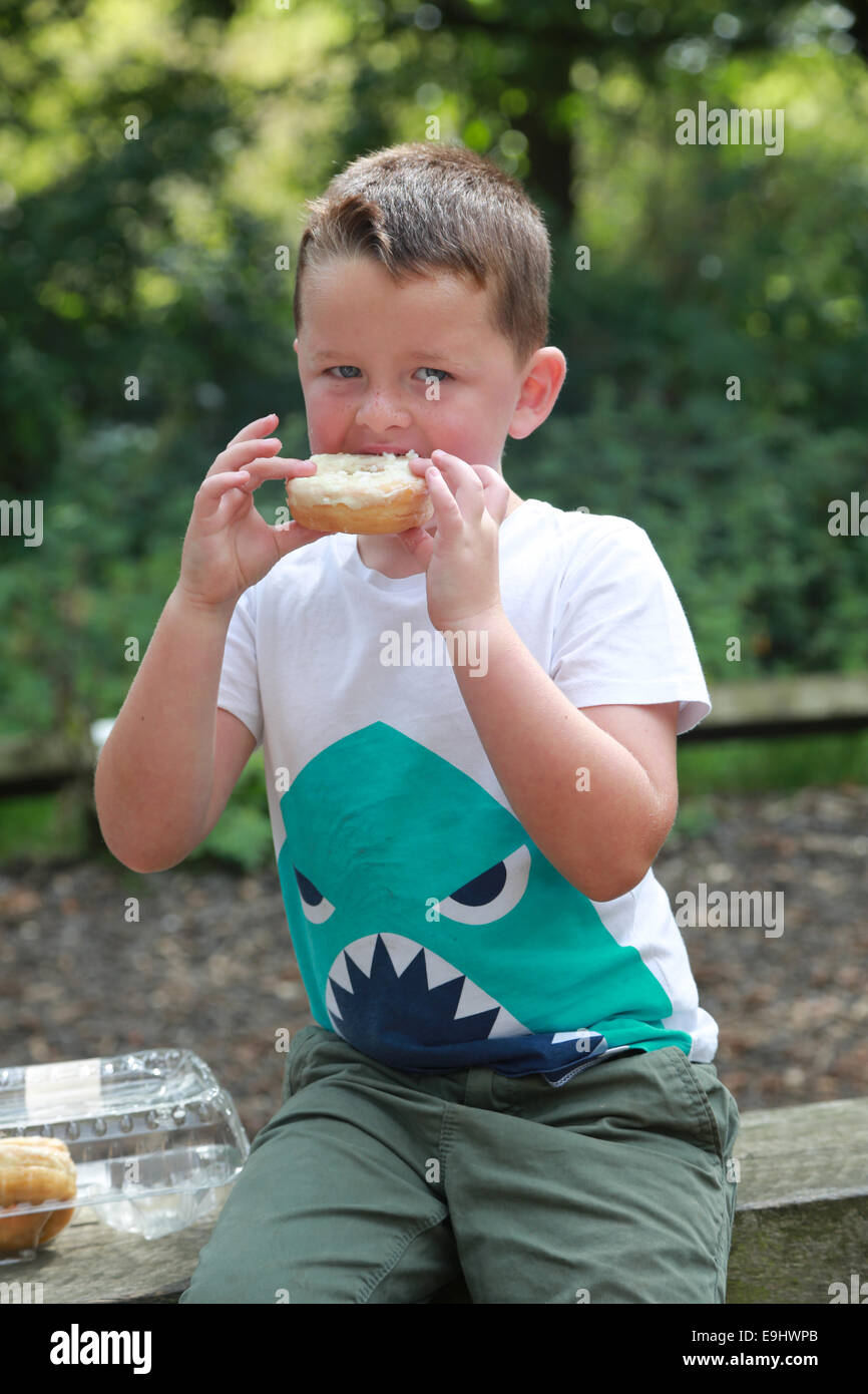 5-year-old-boy-eating-a-doughnut-stock-photo-alamy