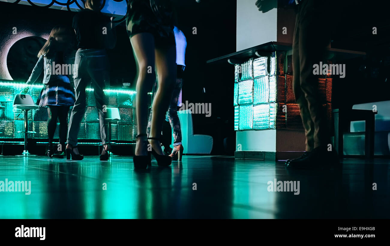 Dancing legs on the floor of night club. Motion blur Stock Photo