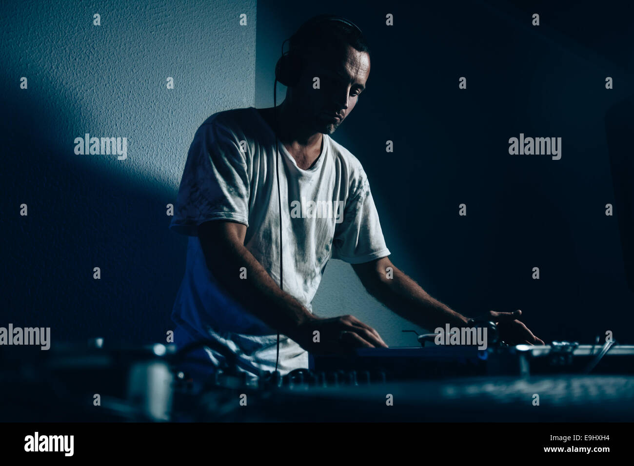Male dj at work in night club. Shallow depth of field Stock Photo