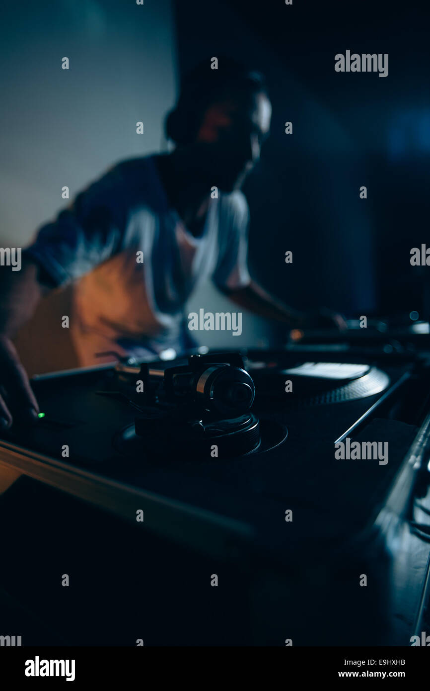Male dj at work in night club. Selective focus on foreground Stock Photo