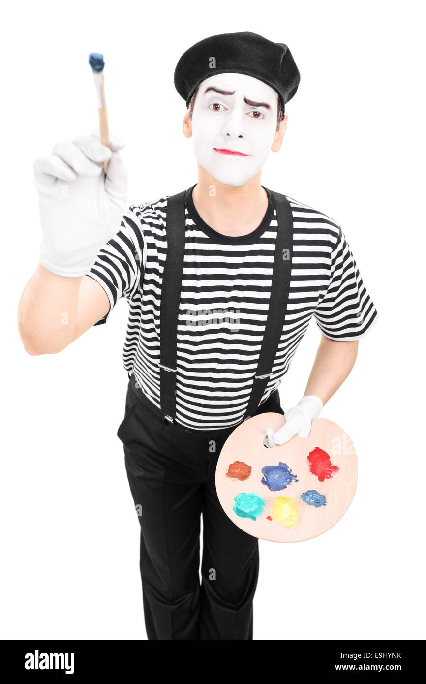Male mime artist holding a paintbrush and a color pallet isolated on white background Stock Photo