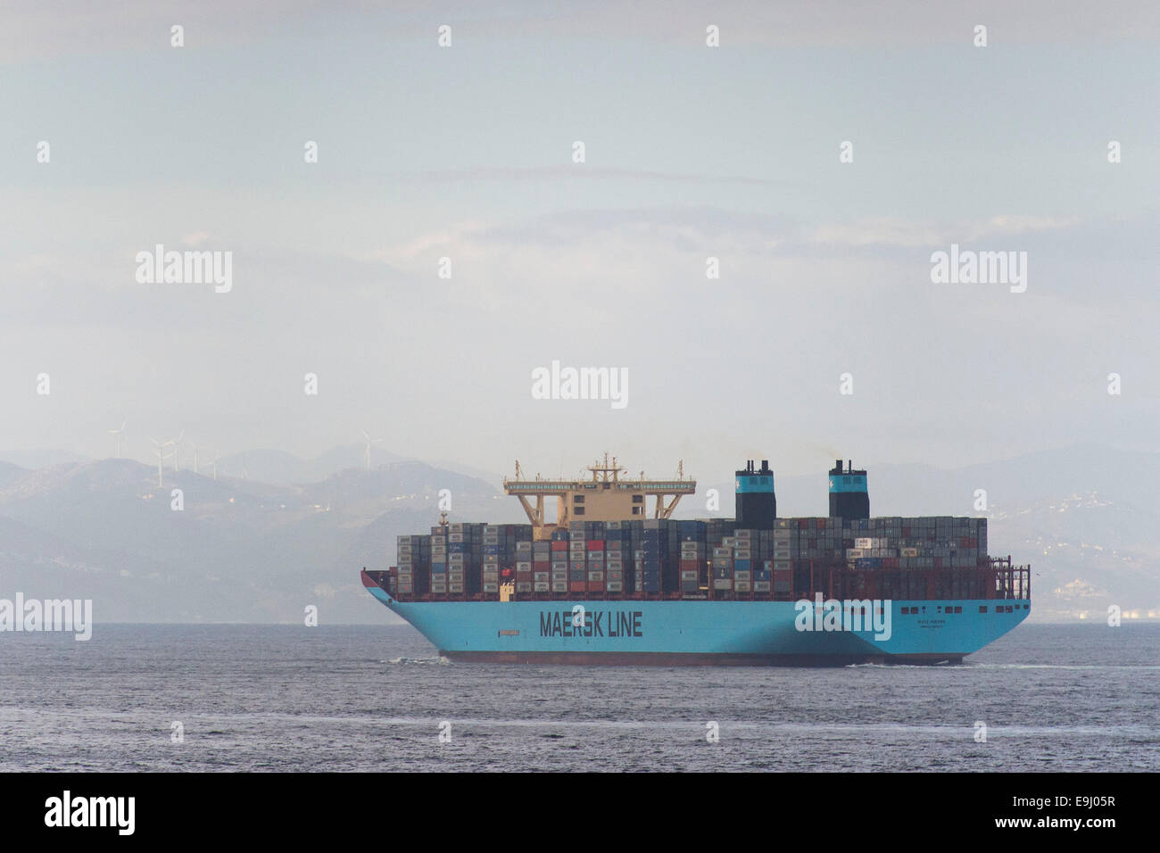 Maersk line transport ship at sea carrying shipping and cargo containers for import and export. Stock Photo