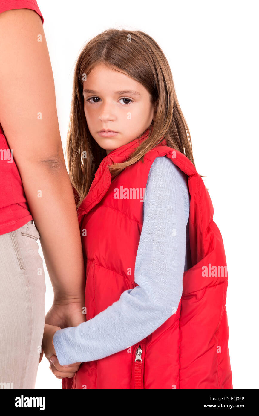 Young girl looking backwards and holding her mother's hand Stock Photo