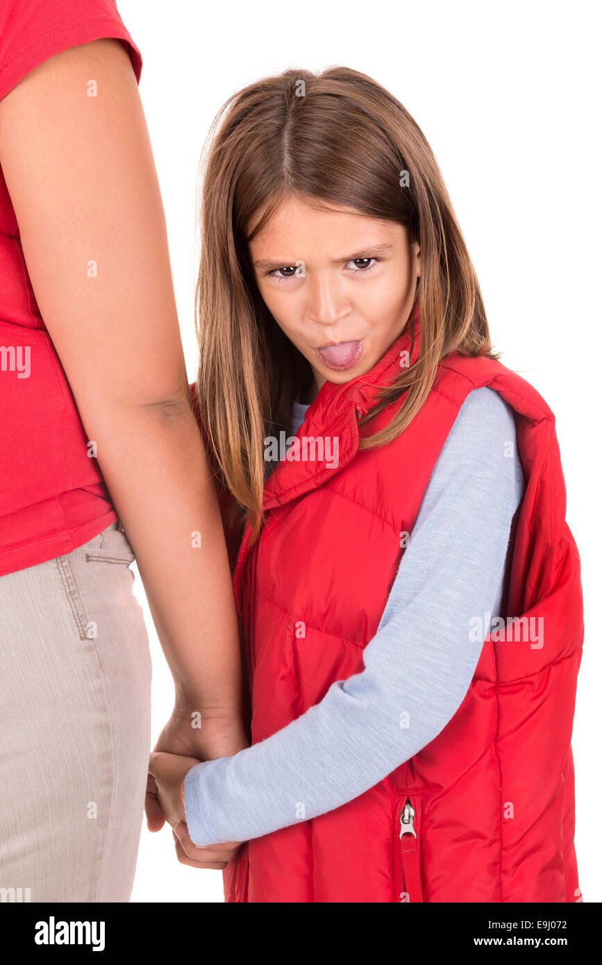 Young girl making faces and holding her mother's hand Stock Photo