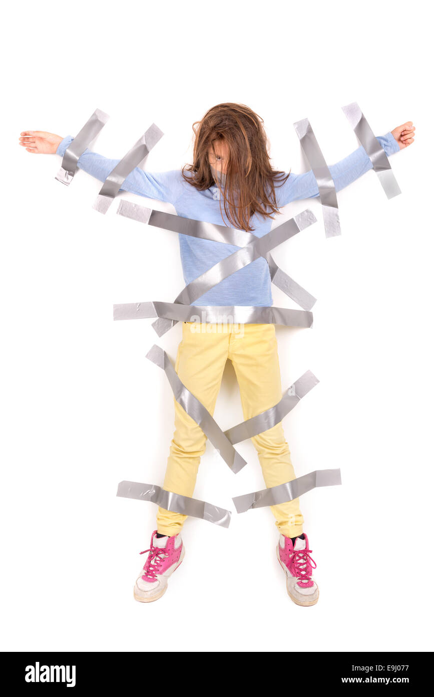 Young girl tied to the wall with duct tape Stock Photo