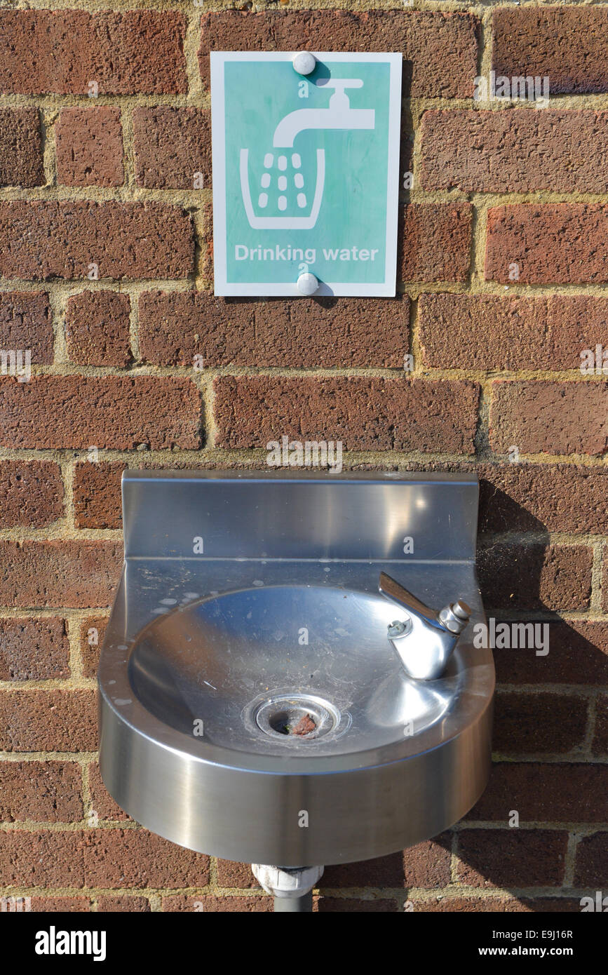 drinking water drink fountain and sign on a brick wall Stock Photo - Alamy