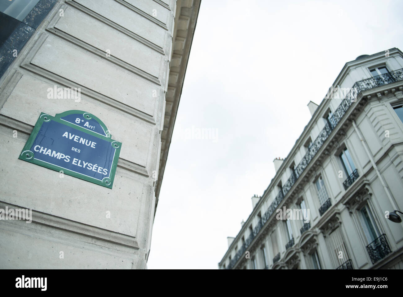 typically french street road name sign posts for the Champs Elysees in Paris on the buildings Stock Photo
