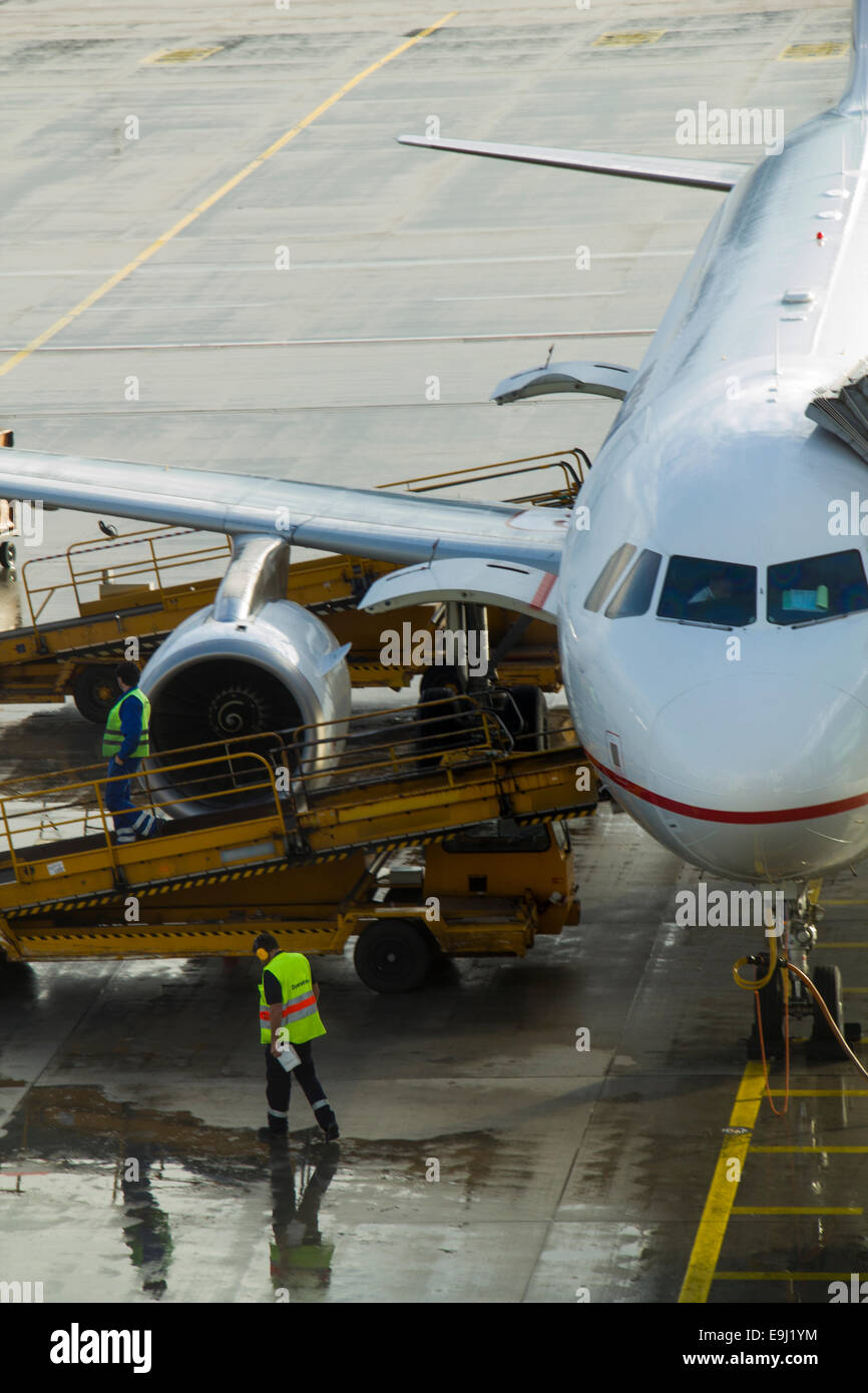 Passenger aircraft maintenance before flight at airport.Ground crew