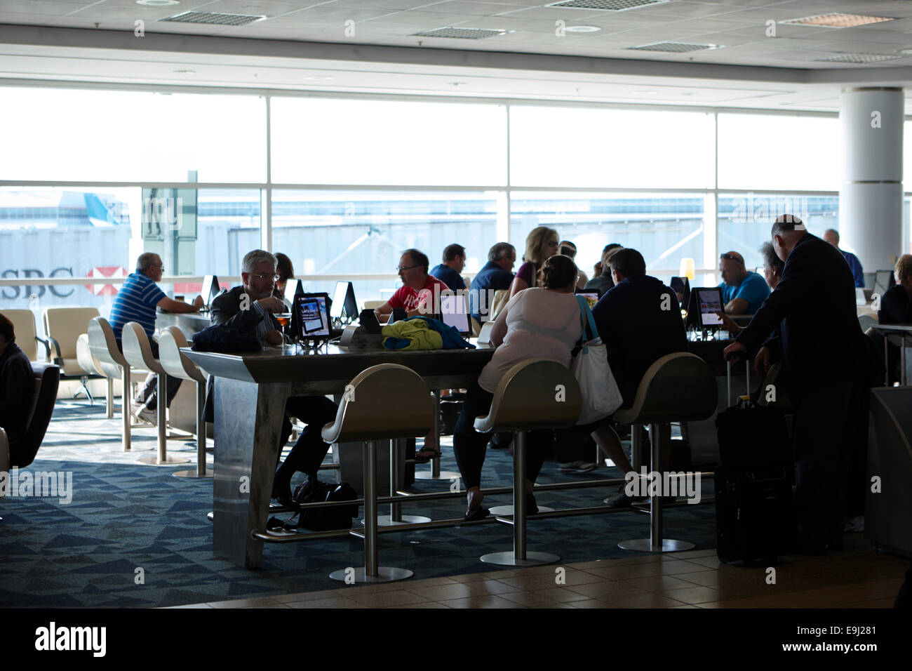 passengers using free wifi terminals at terminal 3 toronto pearson international airport Canada Stock Photo