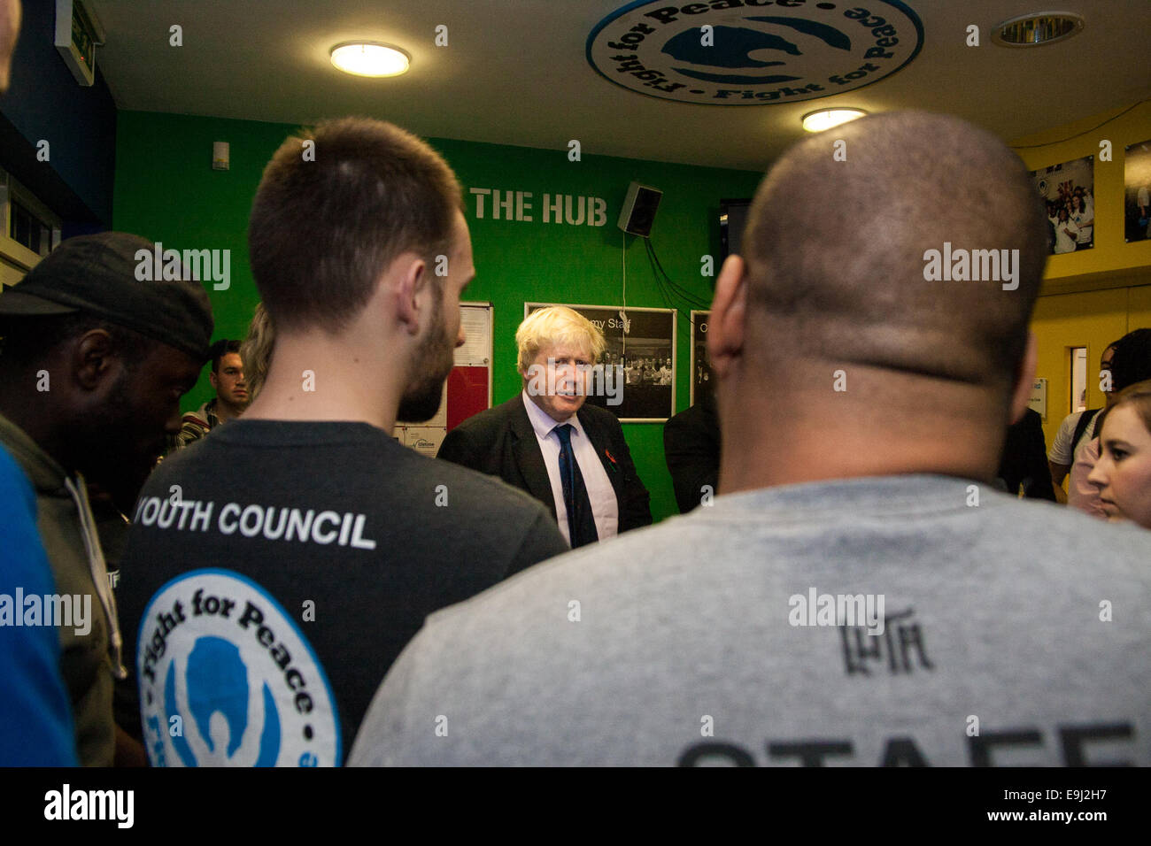 London, UK. 28th October, 2014.  The Mayor of London, Boris Johnson, visits a training session at Fight for Peace Academy in Newham. Fight for Peace uses boxing and martial arts combined with education and personal development to realise the potential of young people in the borough at risk of crime and violence. First established in Rio in 2000 by Luke Dowdney MBE, it was replicated in Newham in 2007. It is now expanding globally and began rolling out across the UK. Pictured: Mayor Boris Johnson speaks with members of Fight for Peace before stepping into the ring. Credit:  Paul Davey/Alamy Liv Stock Photo