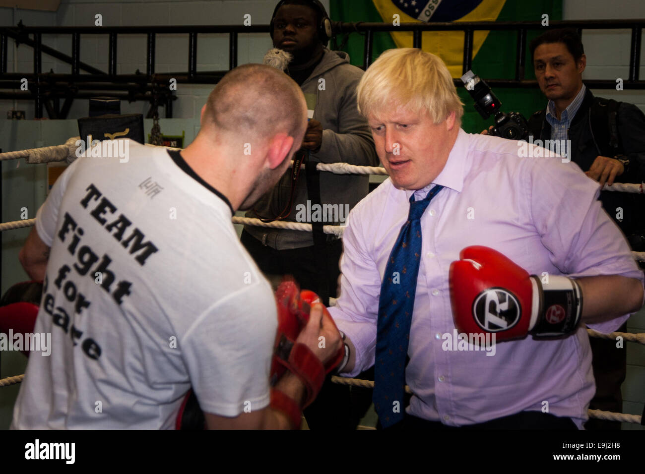 London, UK. 28th October, 2014.  The Mayor of London, Boris Johnson, visits a training session at Fight for Peace Academy in Newham. Fight for Peace uses boxing and martial arts combined with education and personal development to realise the potential of young people in the borough at risk of crime and violence. First established in Rio in 2000 by Luke Dowdney MBE, it was replicated in Newham in 2007. It is now expanding globally and began rolling out across the UK. Credit:  Paul Davey/Alamy Live News Stock Photo