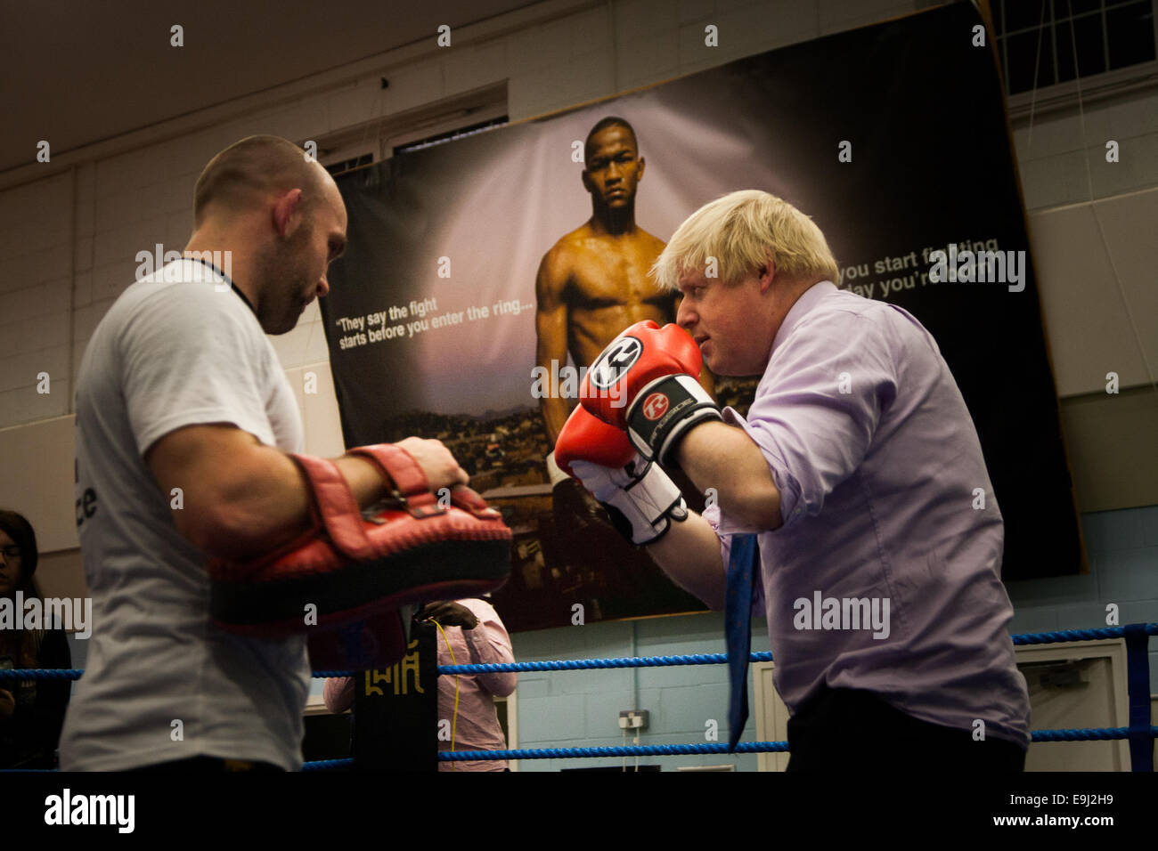 London, UK. 28th October, 2014.  The Mayor of London, Boris Johnson, visits a training session at Fight for Peace Academy in Newham. Fight for Peace uses boxing and martial arts combined with education and personal development to realise the potential of young people in the borough at risk of crime and violence. First established in Rio in 2000 by Luke Dowdney MBE, it was replicated in Newham in 2007. It is now expanding globally and began rolling out across the UK. Credit:  Paul Davey/Alamy Live News Stock Photo