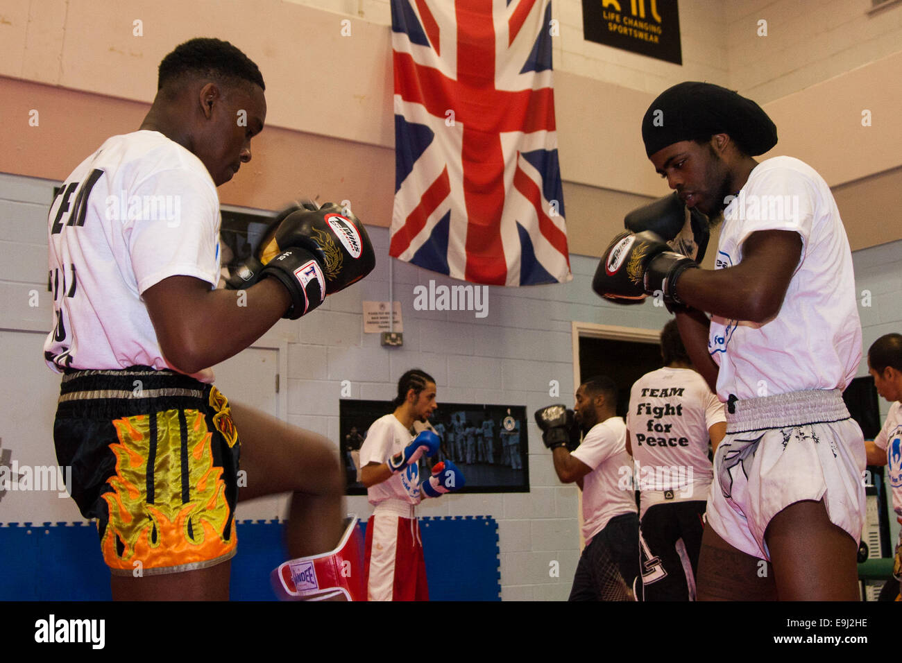 London, UK. 28th October, 2014.  The Mayor of London, Boris Johnson, visits a training session at Fight for Peace Academy in Newham. Fight for Peace uses boxing and martial arts combined with education and personal development to realise the potential of young people in the borough at risk of crime and violence. First established in Rio in 2000 by Luke Dowdney MBE, it was replicated in Newham in 2007. It is now expanding globally and began rolling out across the UK. Pictured: Youth at Fight For Peace practice their kick boxing as they await the arrival of Boris Johnson. © Paul Davey/Alamy Live Stock Photo