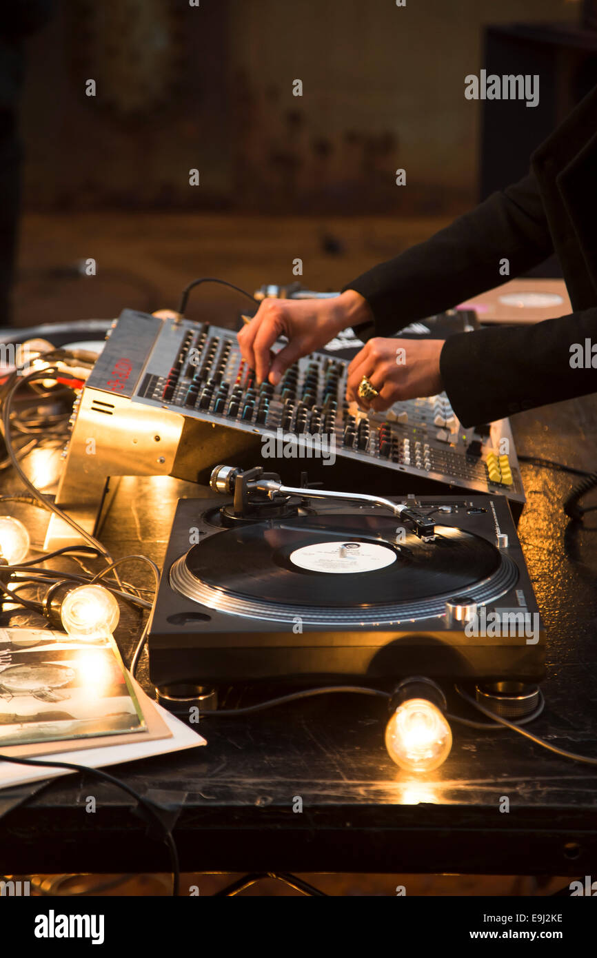 Dj scratching record player and mixing deck at a big party Stock Photo