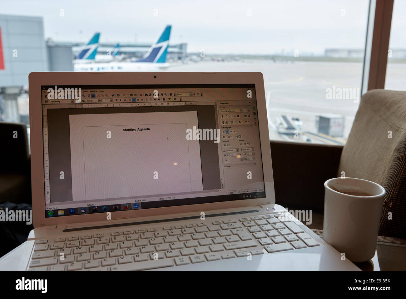 laptop with word document showing meeting agenda in airport business lounge in canada Stock Photo