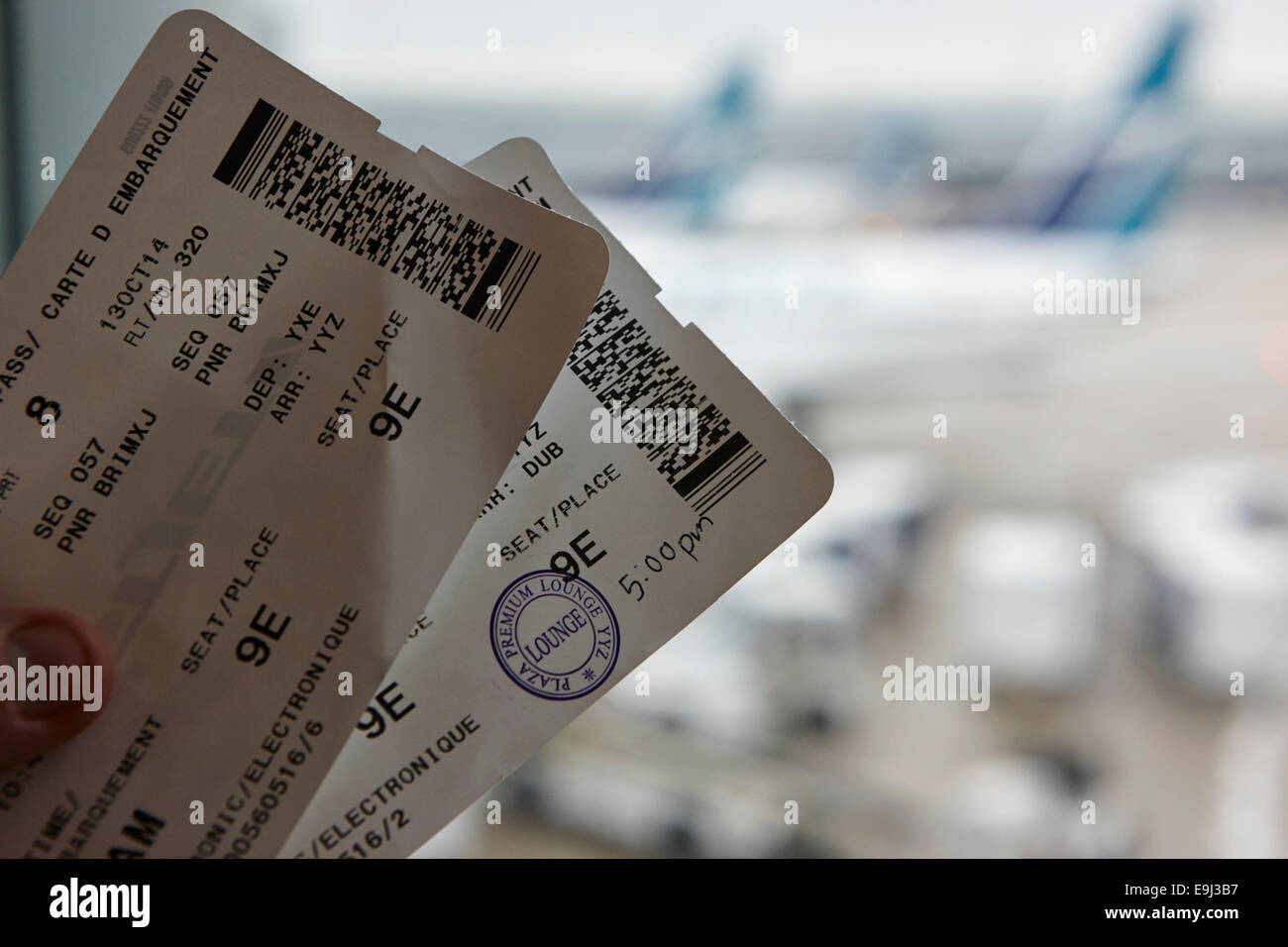 man holding boarding cards in airport business lounge in canada Stock Photo Alamy
