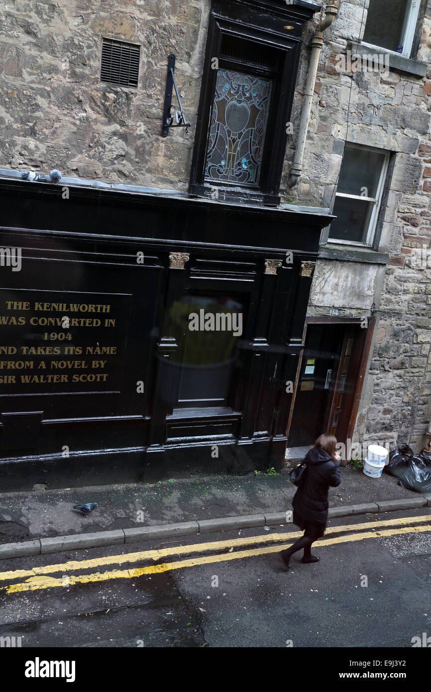 Rose street south lane Woman walking Traditional pub with art