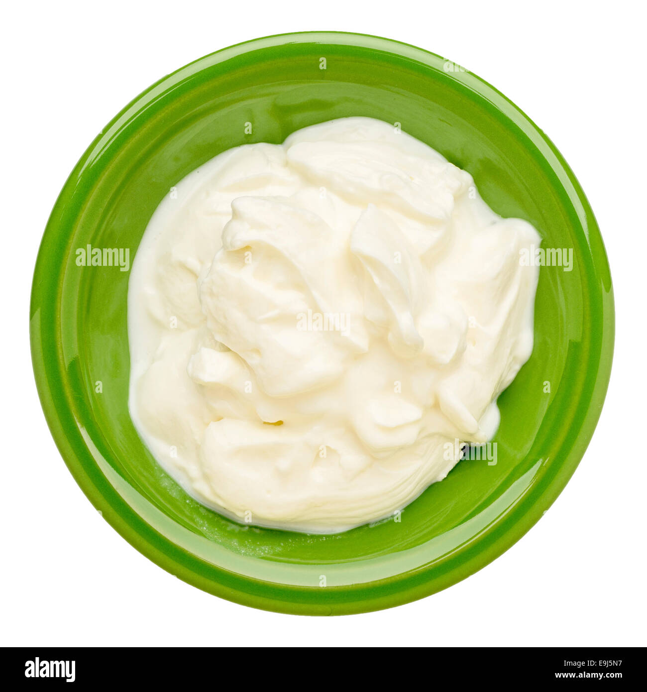 live organic Greek yogurt in an isolated  green ceramic bowl Stock Photo