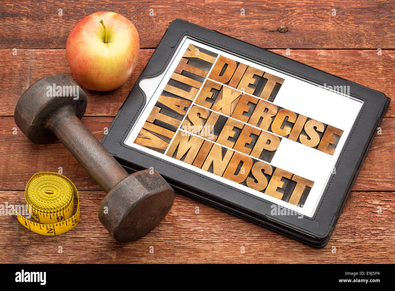 diet, sleep, exercise and mindset - vitality concept - abstract in vintage letterpress wood type on a digital tablet Stock Photo