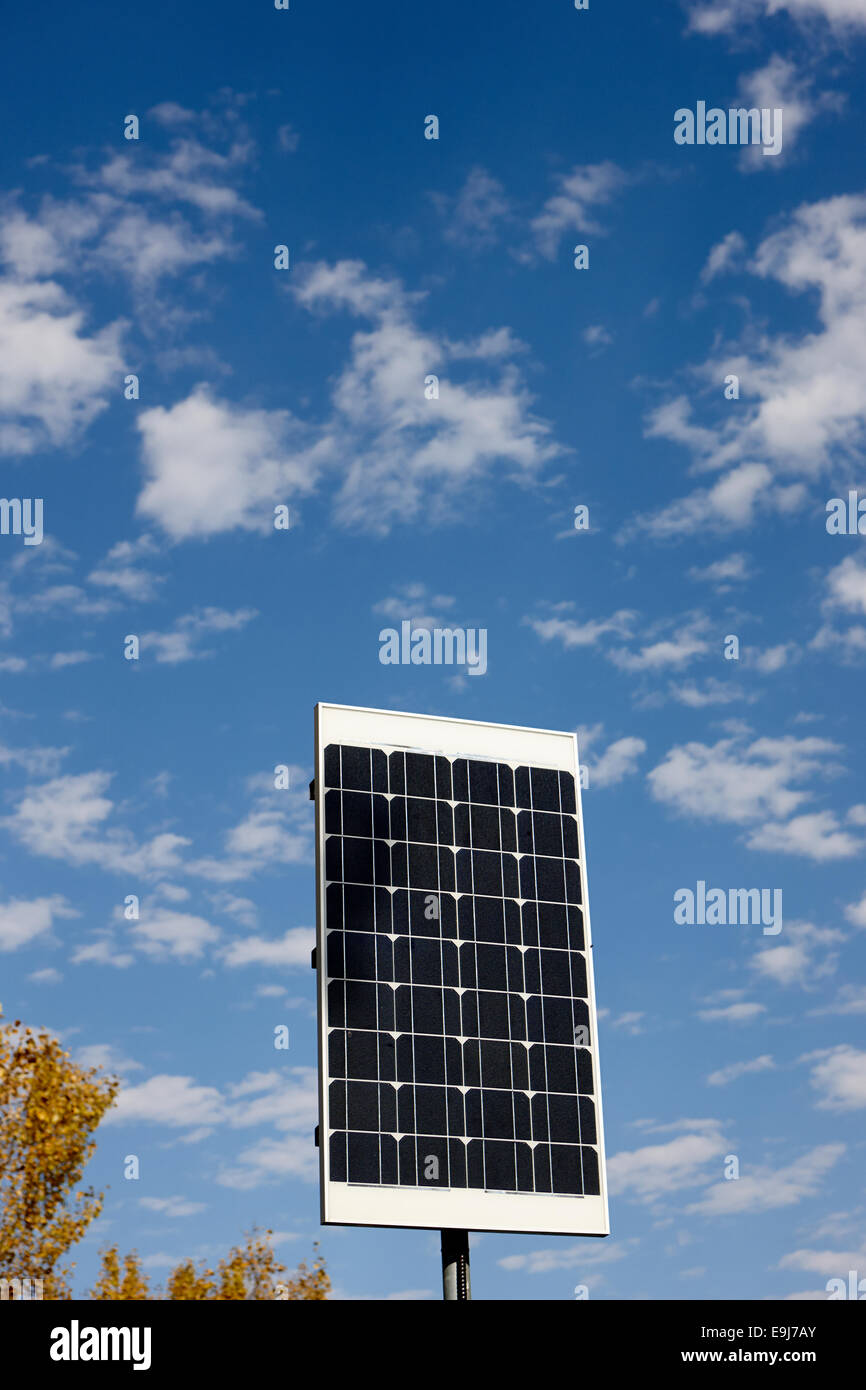 medium sized solar panel against blue cloudy sky on sunny day Stock Photo