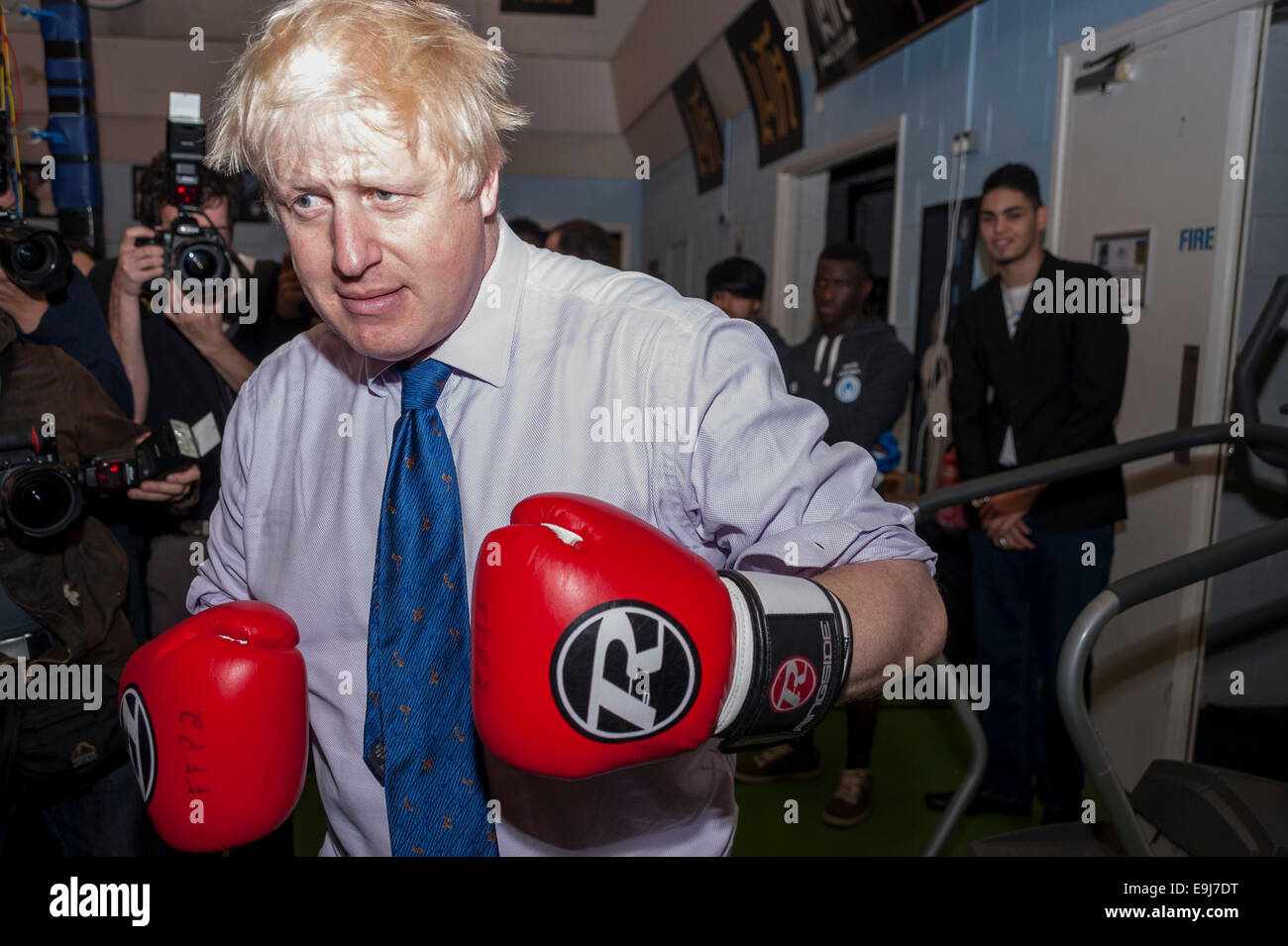 London, UK. 28th October, 2014. The Mayor of London, Boris Johnson visited a training session at Fight for Peace Academy in North Woolwich, Newham where he met some of the young people being helped by the charity. Fight for Peace uses boxing and martial arts combined with education and personal development to realise the potential of young people in the borough at risk of crime and violence.  First established in Rio in 2000 by Luke Dowdney MBE, it was replicated in Newham in 2007and is now expanding globally.  Pictured :  the Mayor enters the ring.   Credit:  Stephen Chung/Alamy Live News Stock Photo