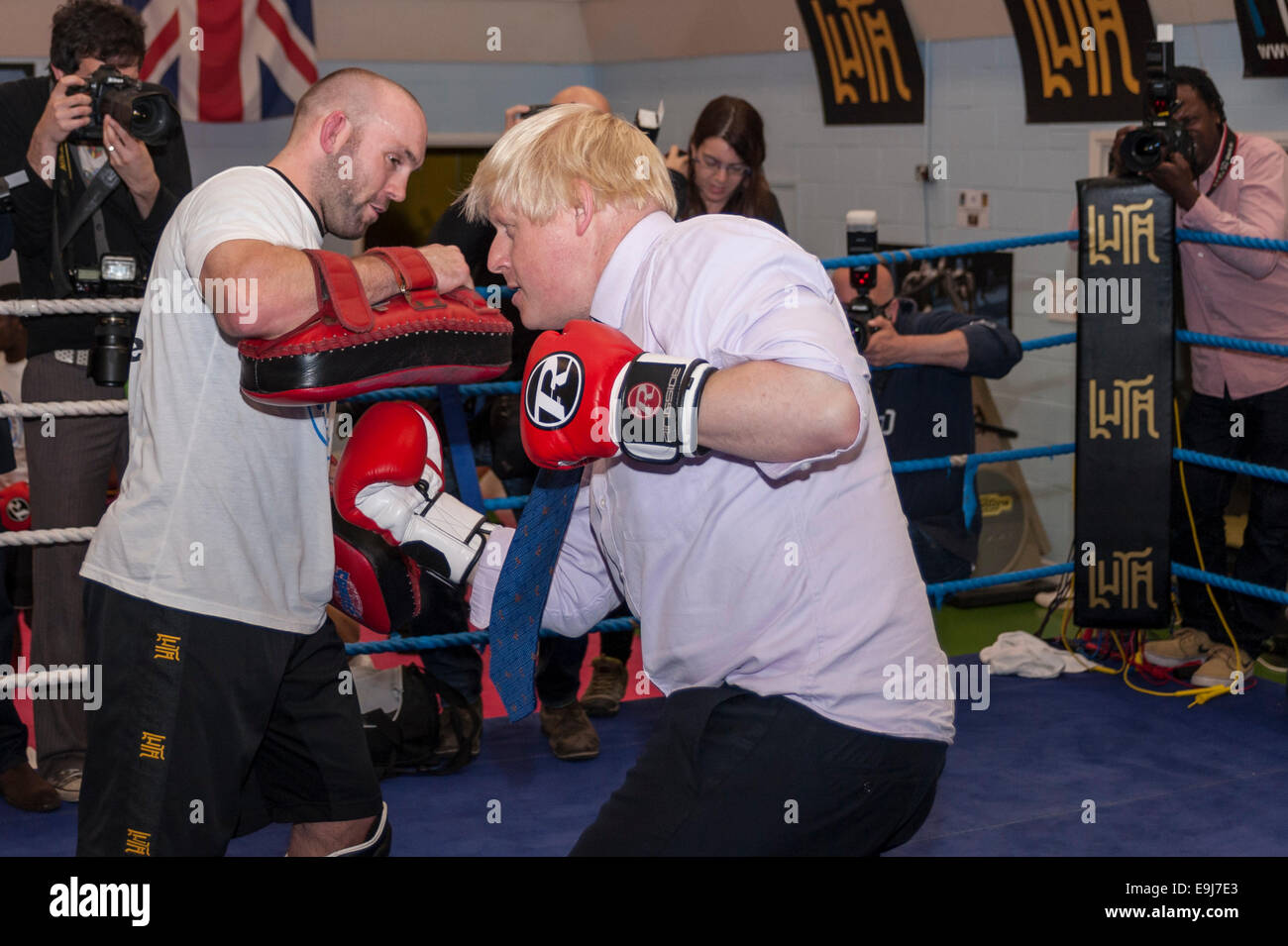 London, UK. 28th October, 2014. The Mayor of London, Boris Johnson visited a training session at Fight for Peace Academy in North Woolwich, Newham where he met some of the young people being helped by the charity. Fight for Peace uses boxing and martial arts combined with education and personal development to realise the potential of young people in the borough at risk of crime and violence.  First established in Rio in 2000 by Luke Dowdney MBE, it was replicated in Newham in 2007and is now expanding globally.  Pictured :  the Mayor in the ring.   Credit:  Stephen Chung/Alamy Live News Stock Photo