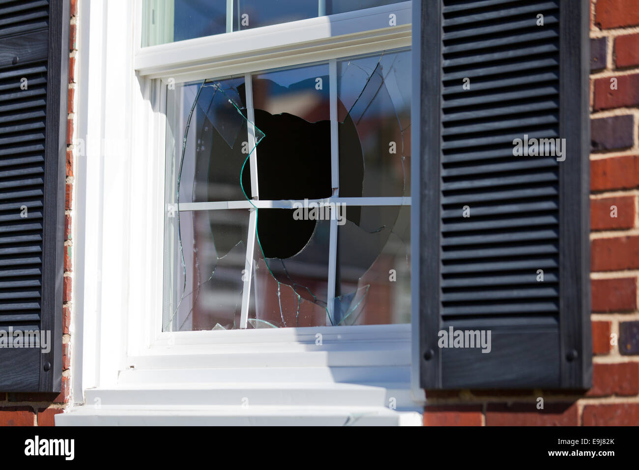Broken window of family home - USA Stock Photo