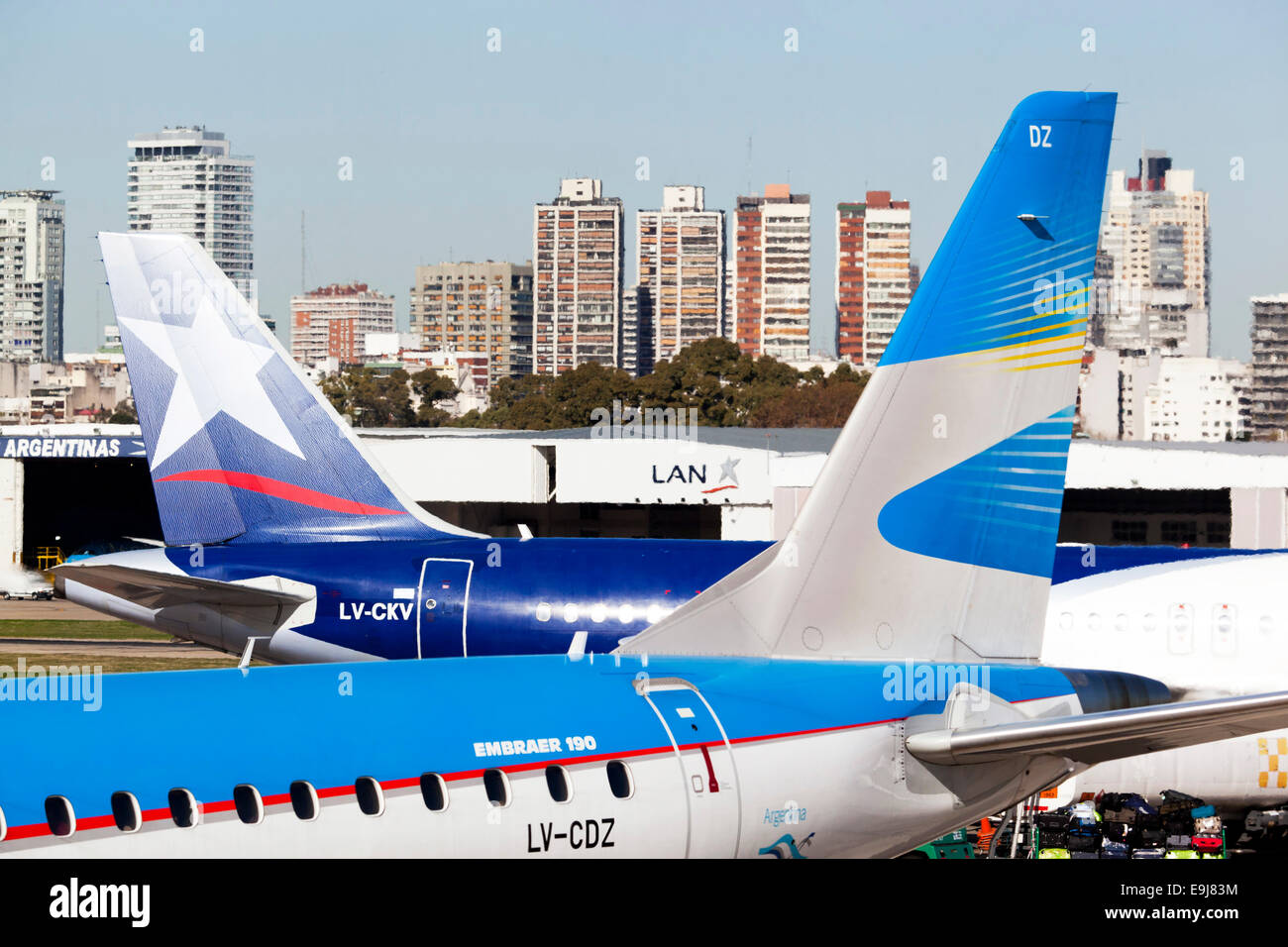 'Lan' and 'Aerolineas Argentinas' airplanes parked in the 'Jorge Newbery' airport (Aeroparque) with the city in background. Buenos Aires, Argentina. Stock Photo