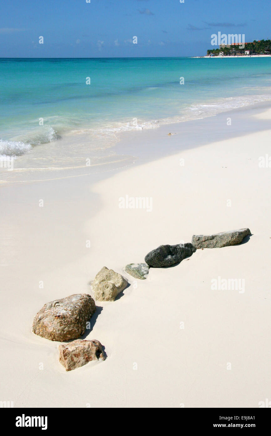 Natural rocks on the beach, with turquoise sea & blue sky, Manchebo Beach, Aruba, Caribbean. Stock Photo