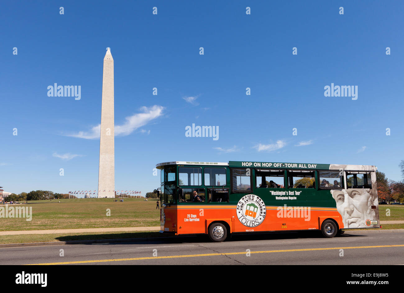 Old Town Trolley sightseeing tour bus passing the Washington Monument
