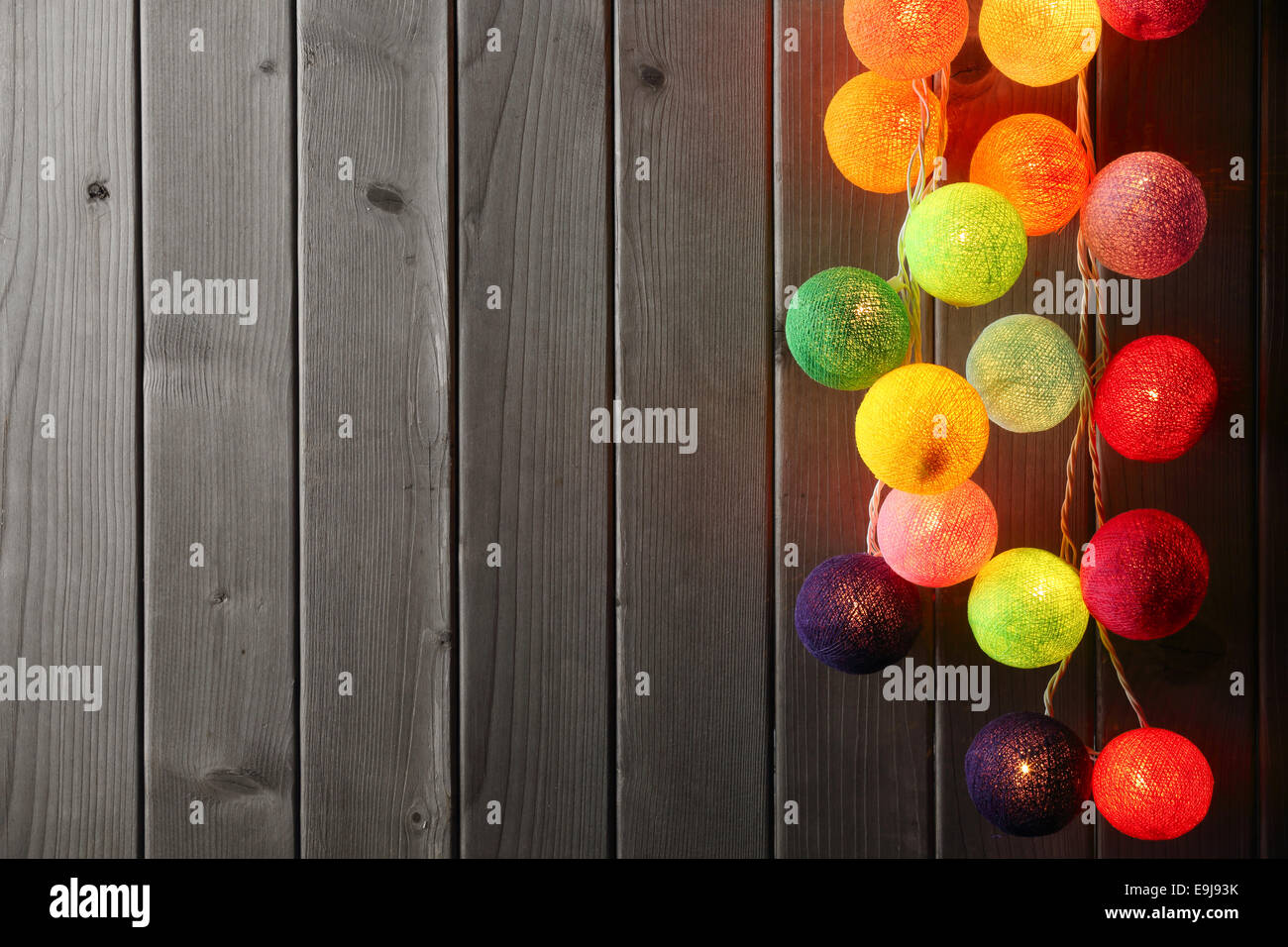 Christmas ball lights over wood plank. Stock Photo