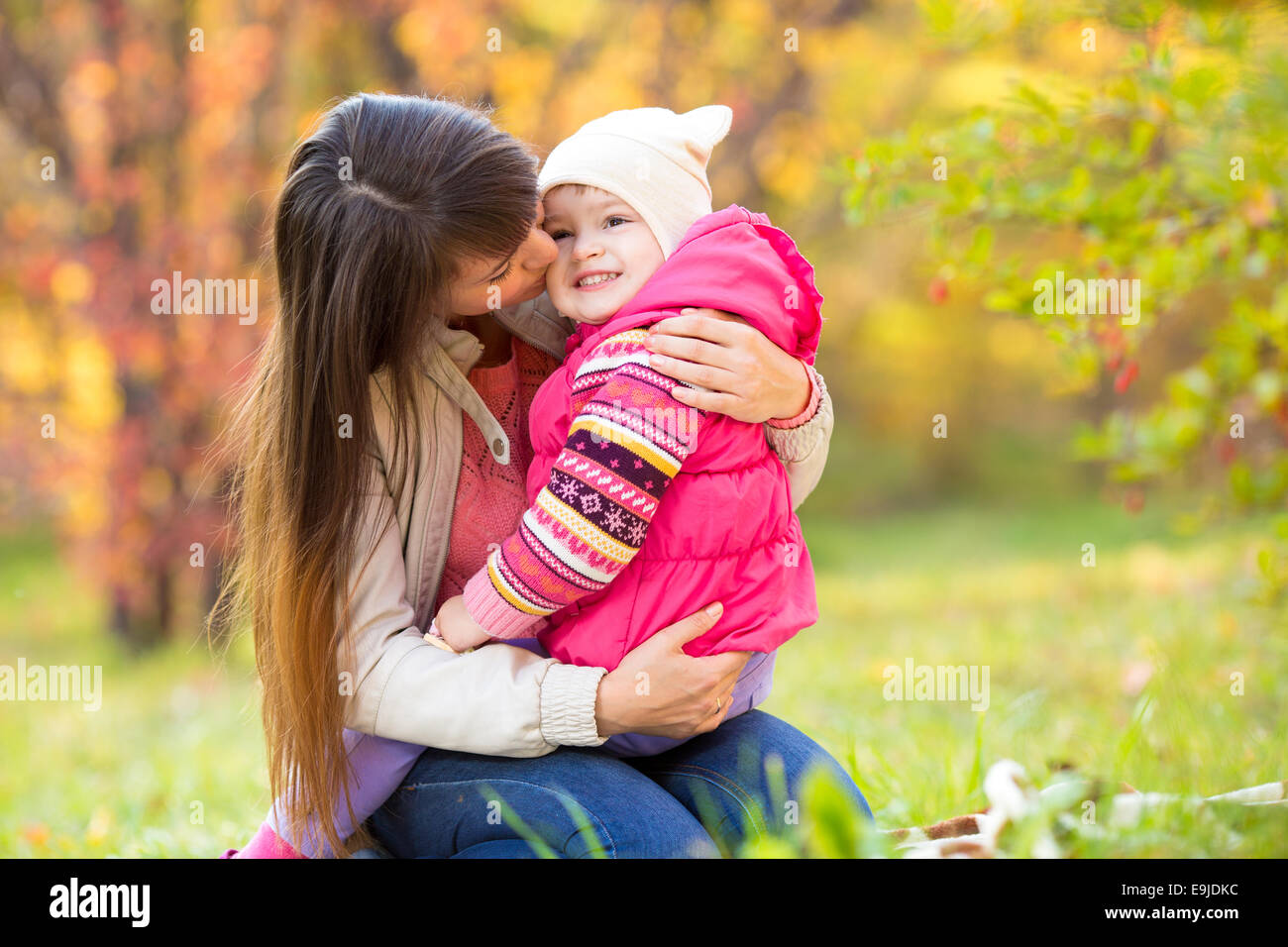 beautiful mother with kid girl outdoors in autumn Stock Photo