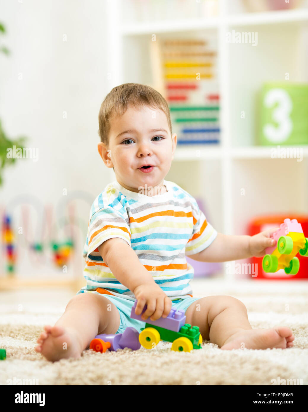 Child playing with building blocks at home Stock Photo - Alamy