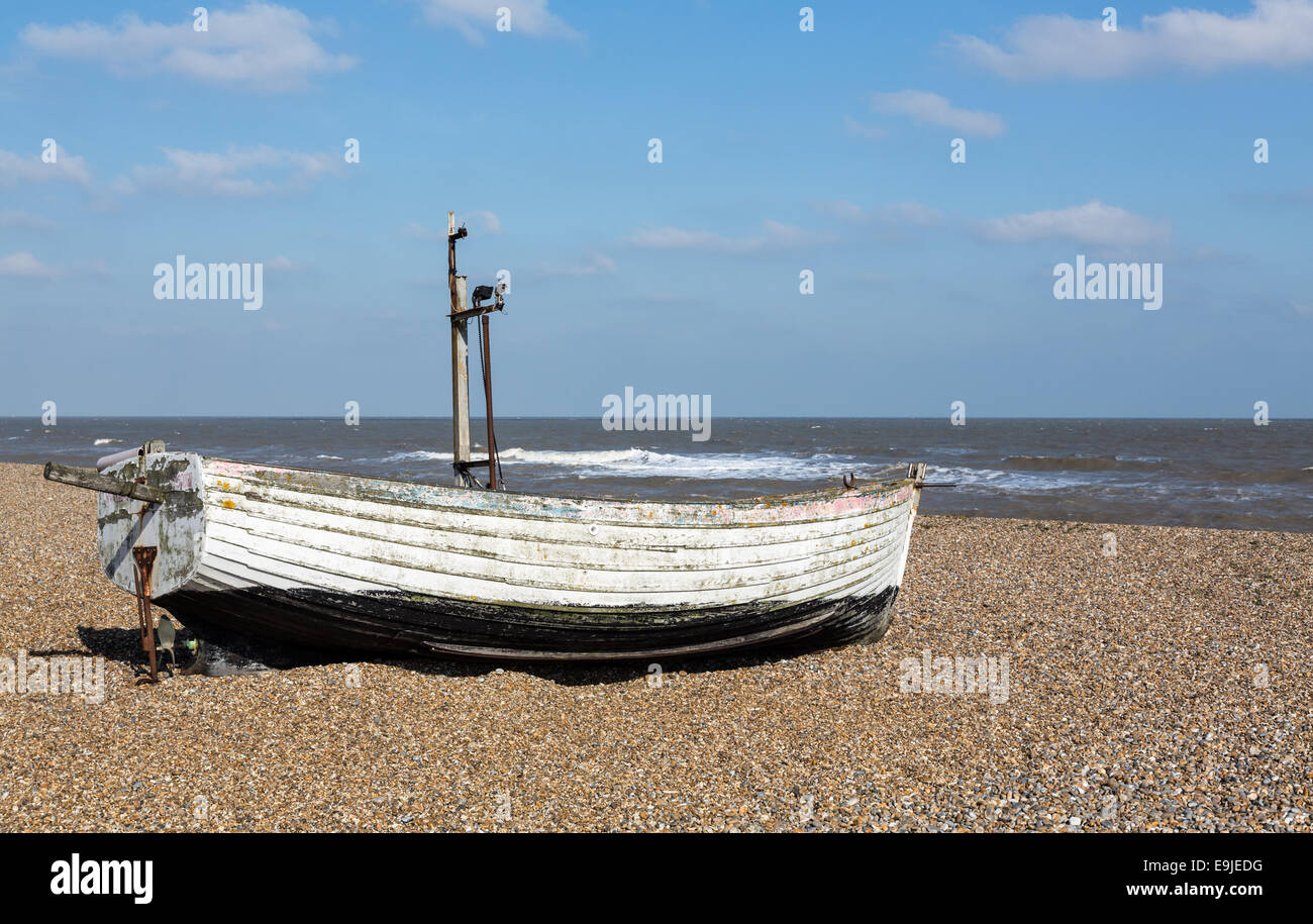 Old fishing boat on pebble beach Stock Photo - Alamy