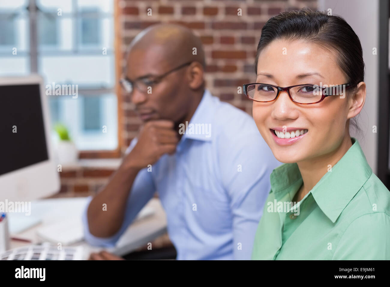 Smiling female photo editor in office Stock Photo Alamy