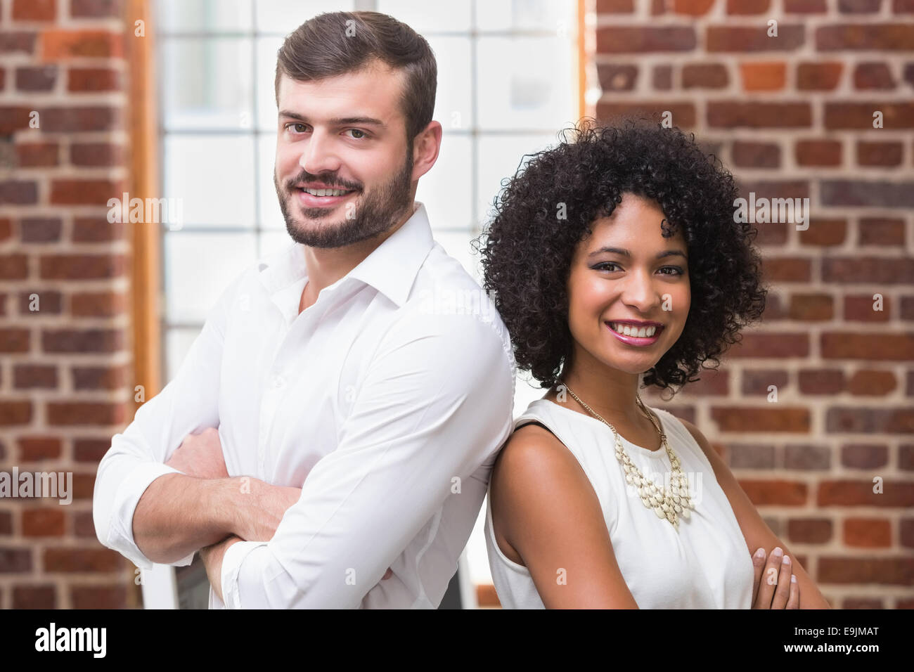 Confident business people with arms crossed in office Stock Photo - Alamy