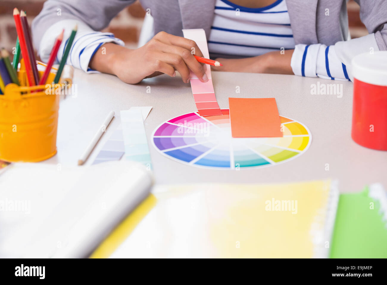 Mid section of designer with color samples at desk Stock Photo