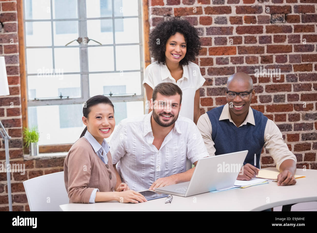 Creative business team using laptop in meeting Stock Photo - Alamy