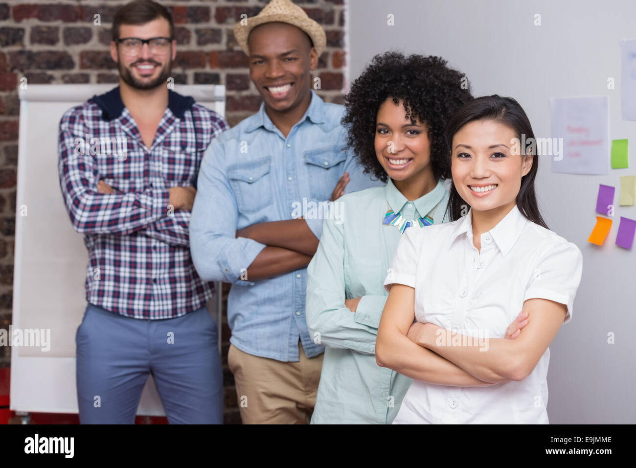 Portrait of creative team with arms crossed in office Stock Photo - Alamy