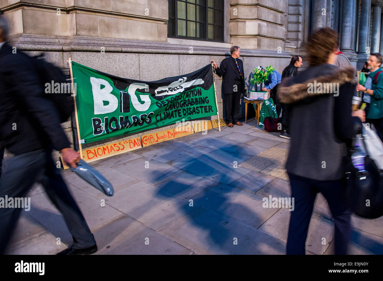 London, UK. 28th Oct, 2014. Environmental campaigners protest outside the 2nd anniversary investor meeting of the Green Investment Bank.  They are concerned about its support for the use of biomass as a fuel in power stations because it is from unsustainable sources. The meeting takes palce at the the offices of Bank of America Merrill Lynch, St Pauls, London 28 Oct 2014. Credit:  Guy Bell/Alamy Live News Stock Photo