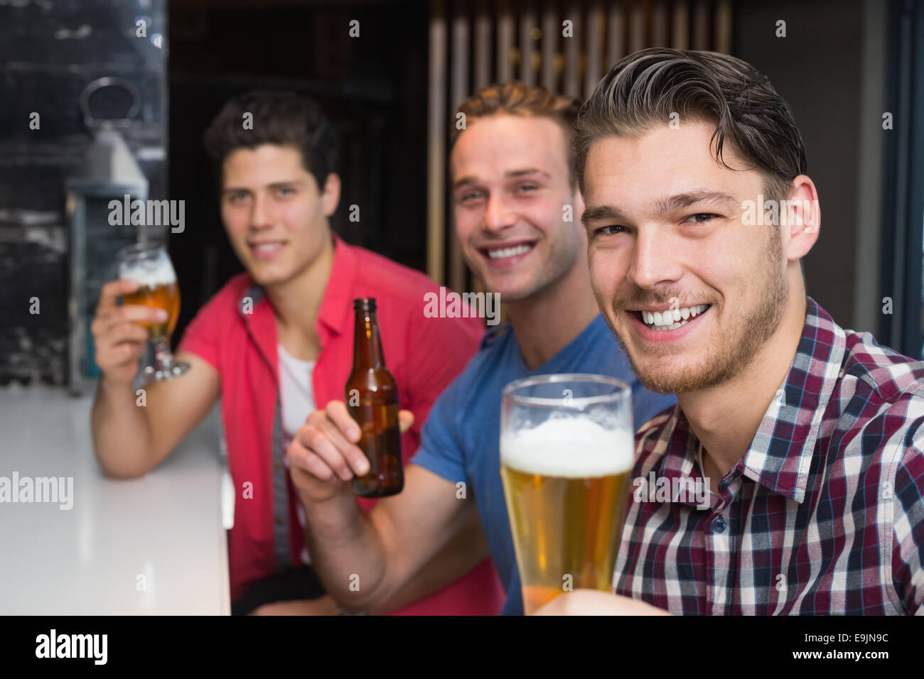 Young men drinking beer together Stock Photo