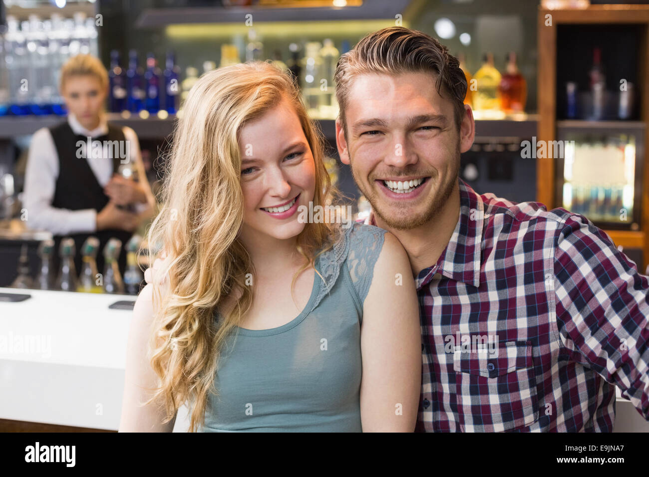 Young couple smiling at the camera Stock Photo - Alamy