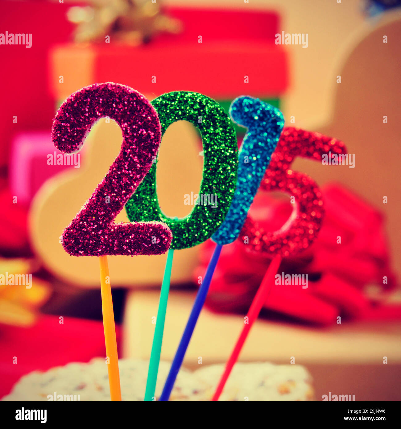 numbers of different colors forming the number 2015, as the new year, with a pile of gifts in the background Stock Photo