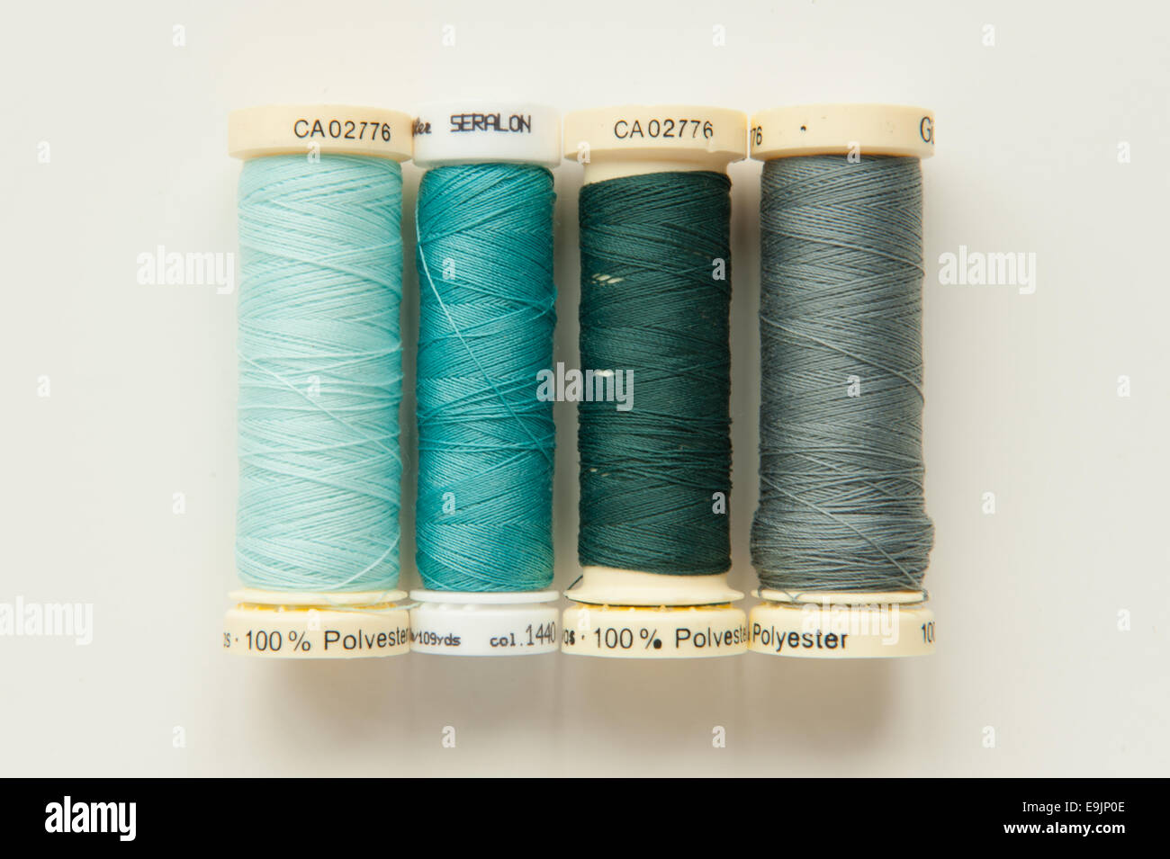Four spools of polyester sewing thread Stock Photo Alamy