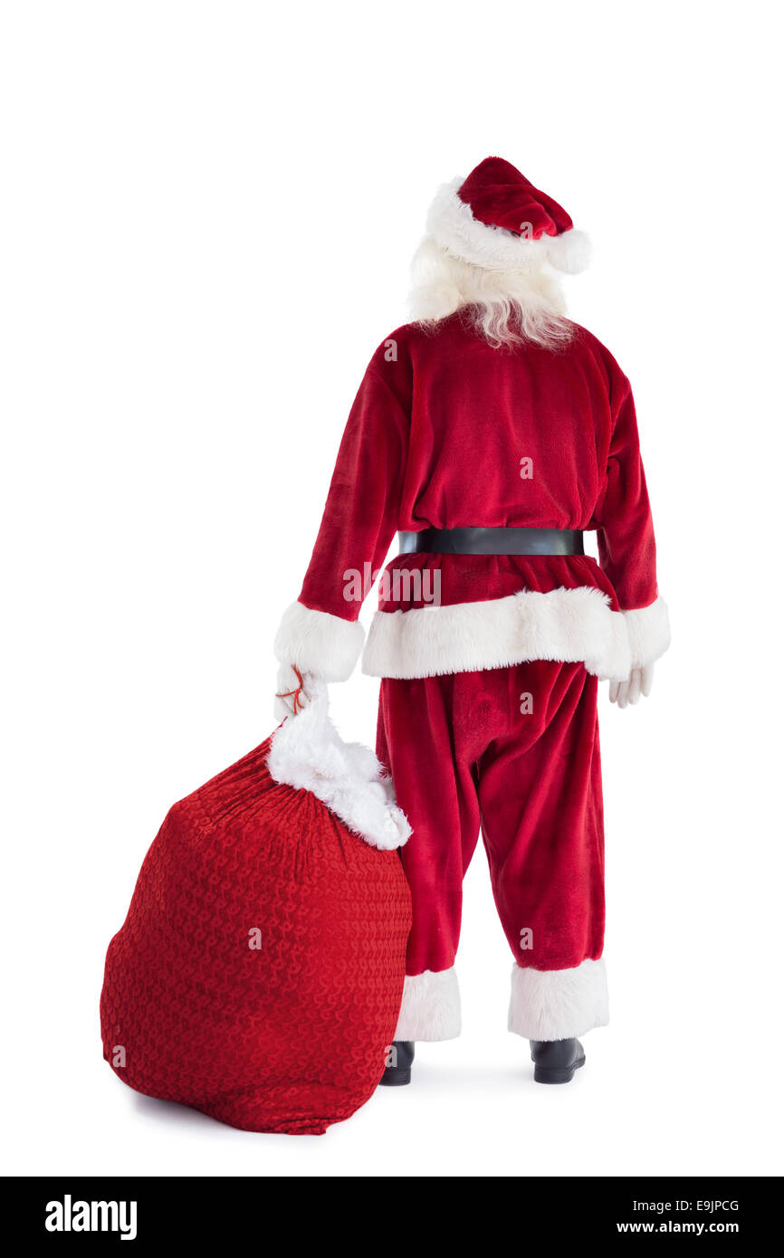 Santa is holding his bag in one hand Stock Photo
